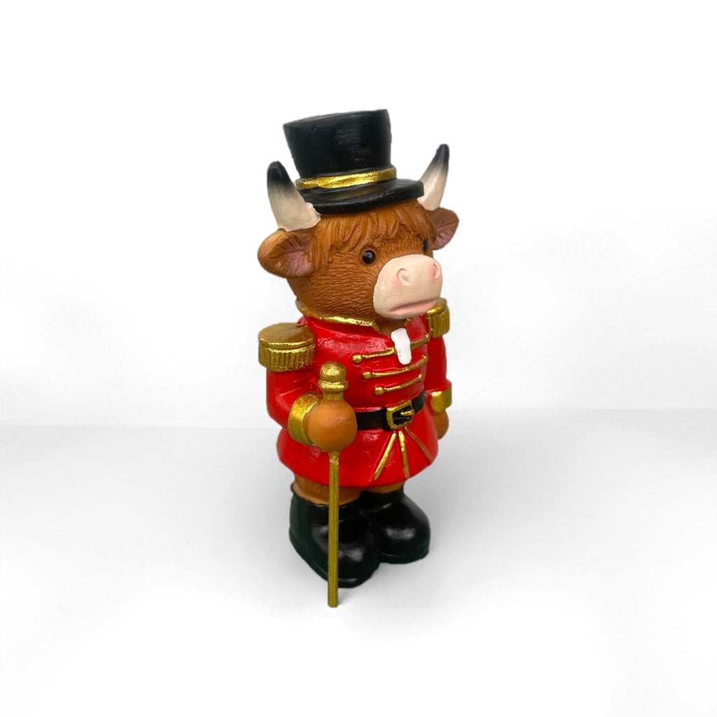 Decorative nutcracker and highland cattle figures made of resin