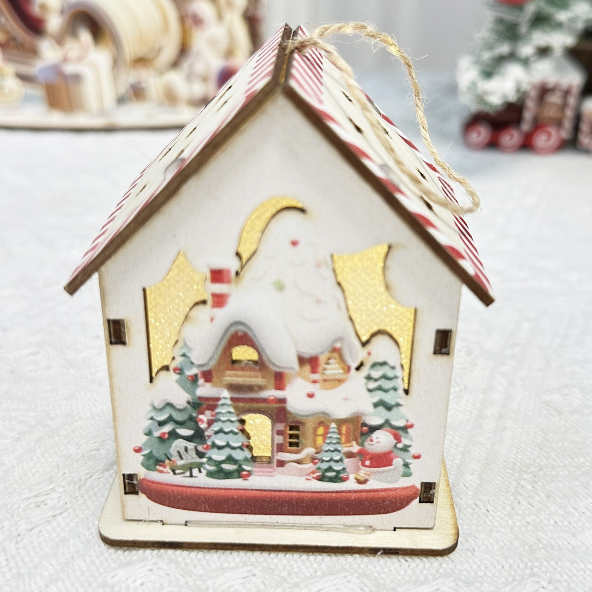 Illuminated wooden house for festive table decoration