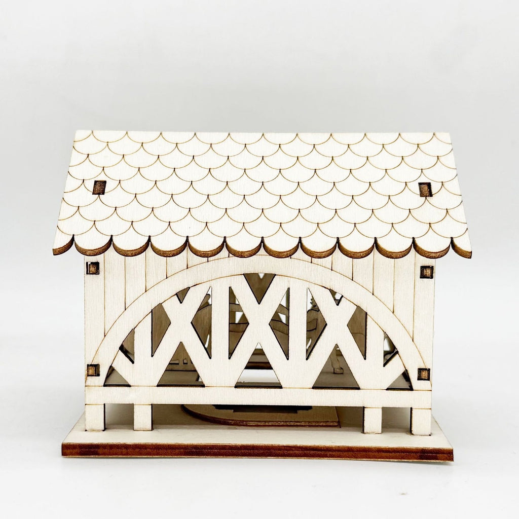Illuminated wooden house with bridge