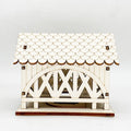 Illuminated wooden house with bridge