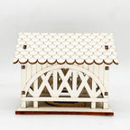 Illuminated wooden house with bridge