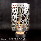 Rotating tea light holder made of brass, openwork design