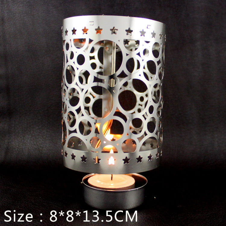 Rotating tea light holder made of brass, openwork design