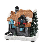 Illuminated miniature Christmas house made of resin