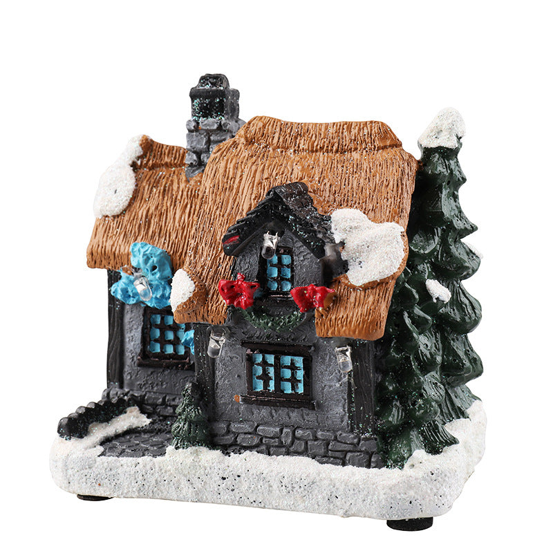 Illuminated miniature Christmas house made of resin