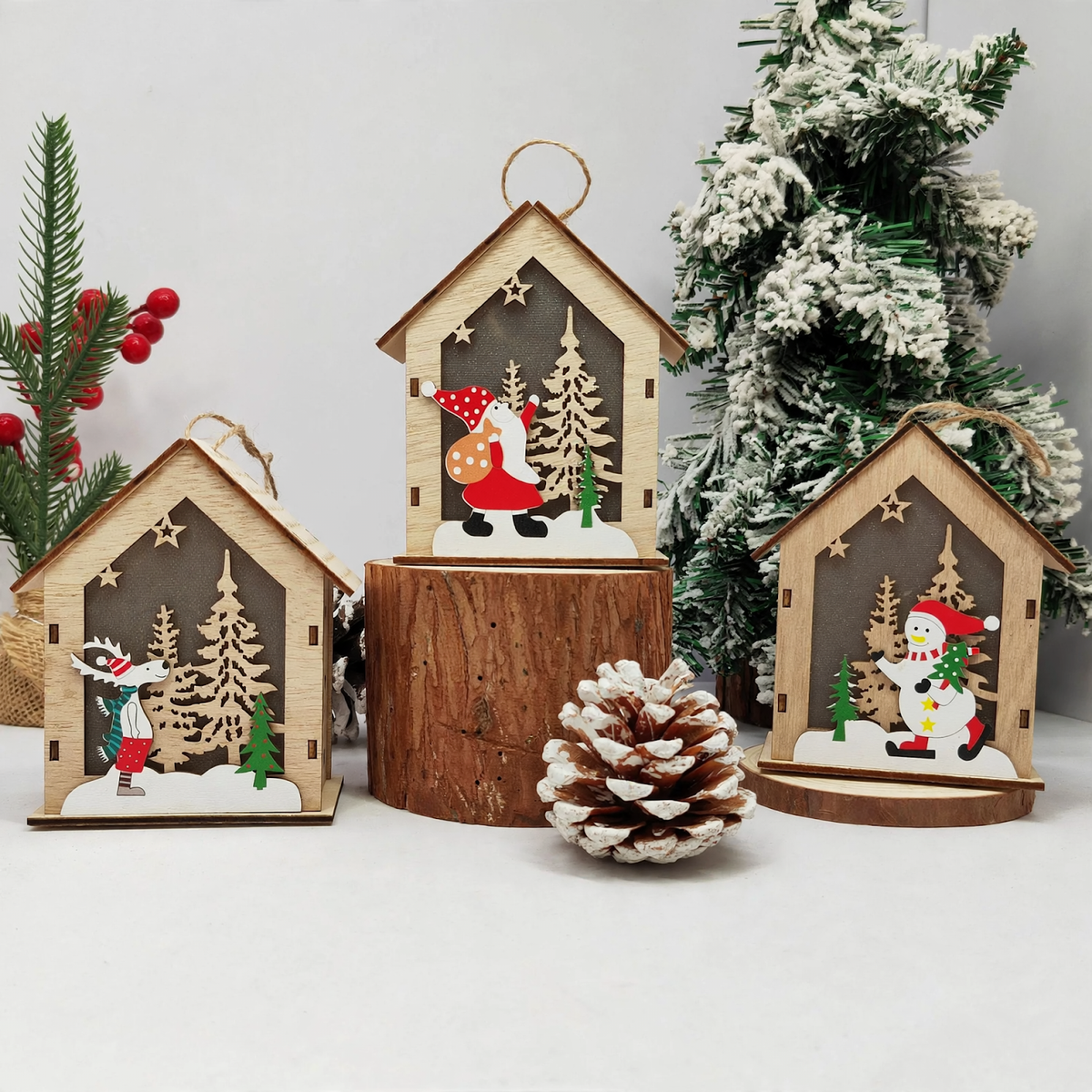 Illuminated wooden Christmas house as tree ornament