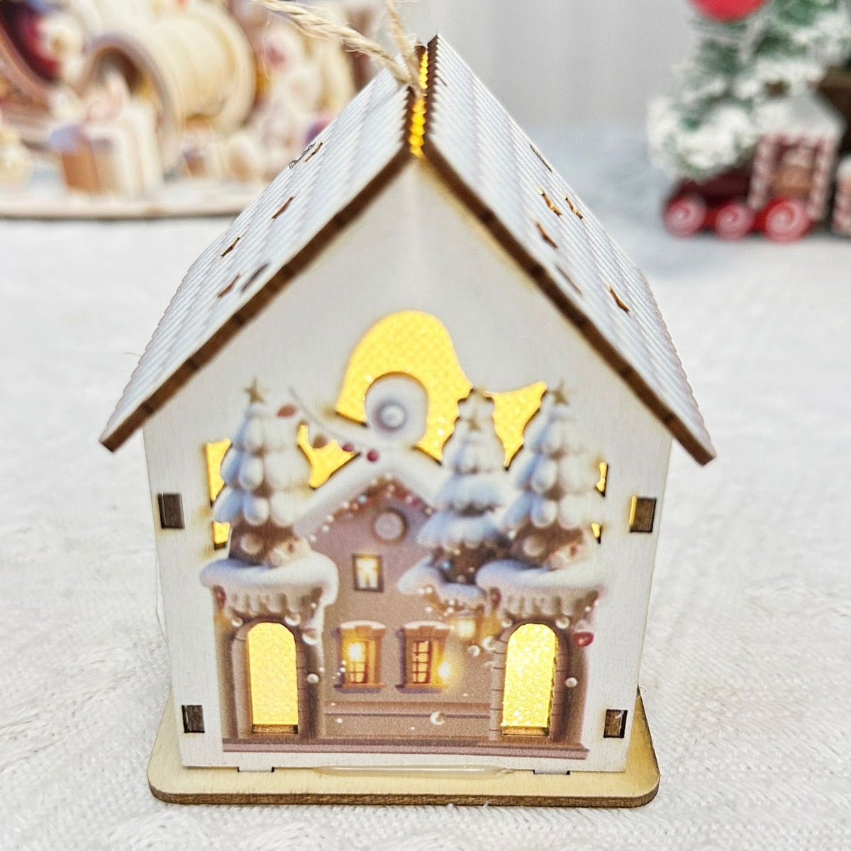 Illuminated wooden house for festive table decoration
