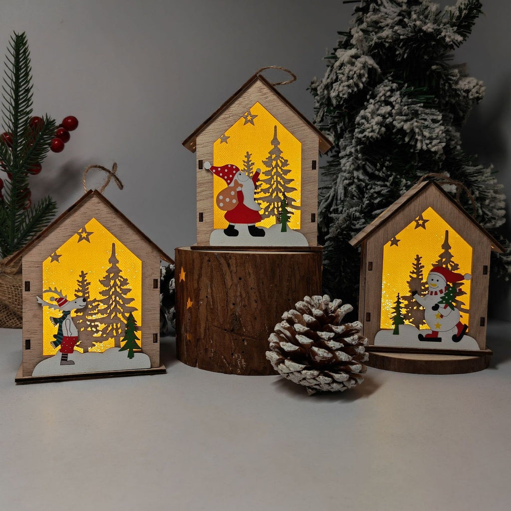 Illuminated wooden Christmas house as tree ornament