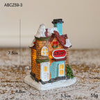 Illuminated Christmas house made of resin for table decoration