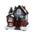 Illuminated miniature Christmas house made of resin