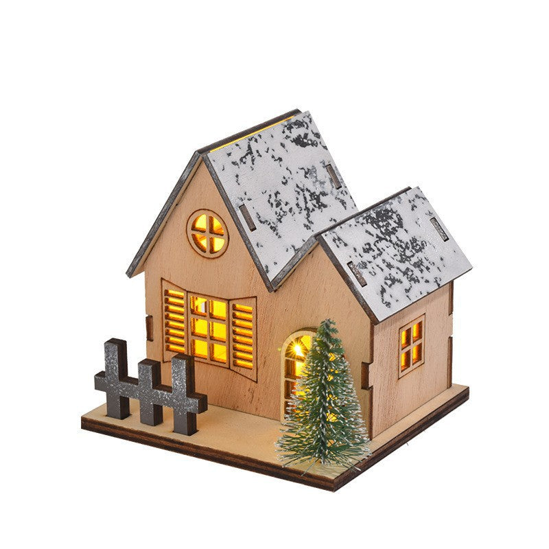 Illuminated wooden house for festive table decoration