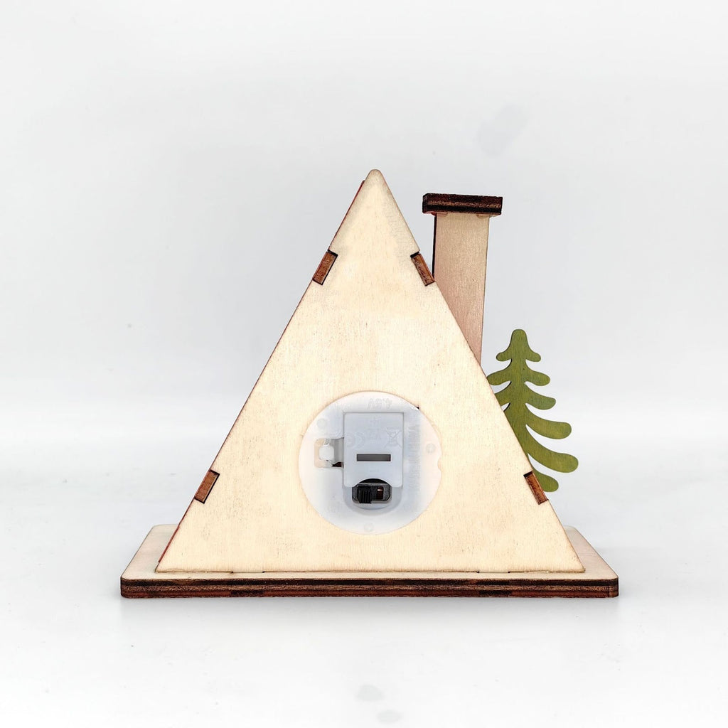 Illuminated wooden house in triangular shape