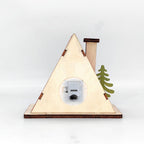 Illuminated wooden house in triangular shape