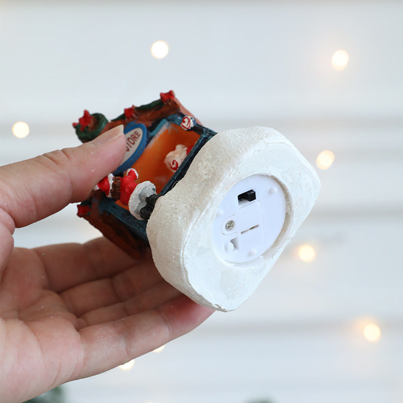 Illuminated Christmas house made of resin for table decoration