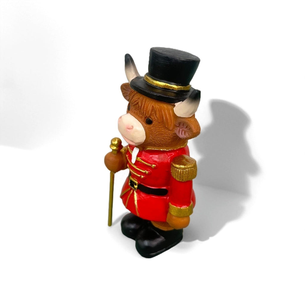 Decorative nutcracker and highland cattle figures made of resin