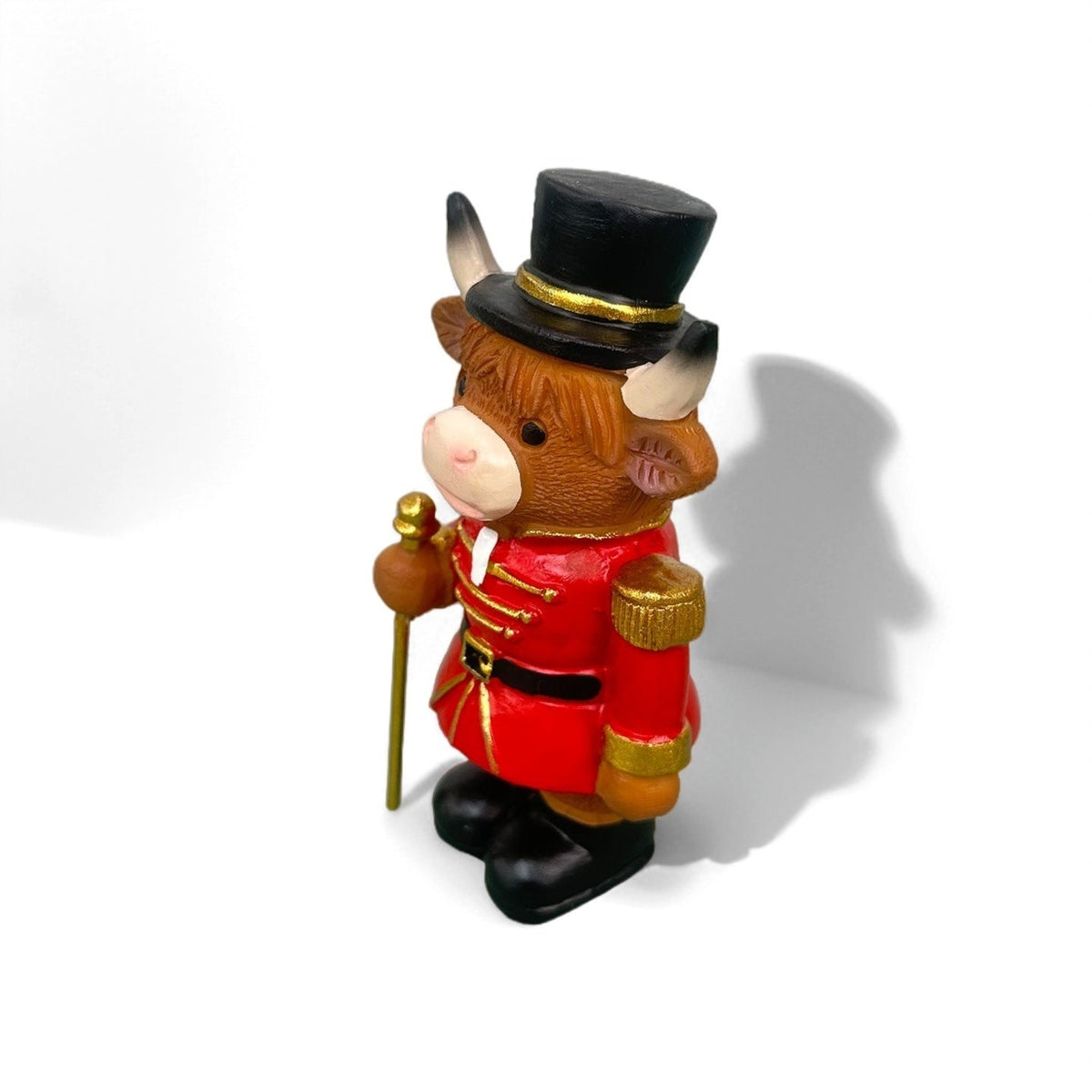 Decorative nutcracker and highland cattle figures made of resin