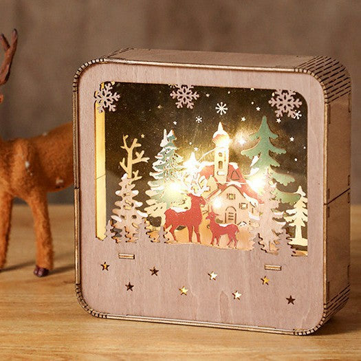 Illuminated wooden house with LED Christmas decoration