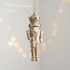 Golden nutcracker pendant made of resin for the Christmas tree