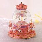 Decorative music box with snow globe and carousel