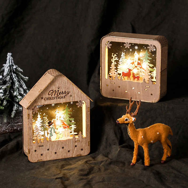 Illuminated wooden house with LED Christmas decoration