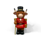 Decorative nutcracker and highland cattle figures made of resin
