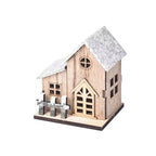Illuminated wooden house for festive table decoration