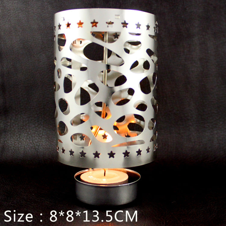 Rotating tea light holder made of brass, openwork design